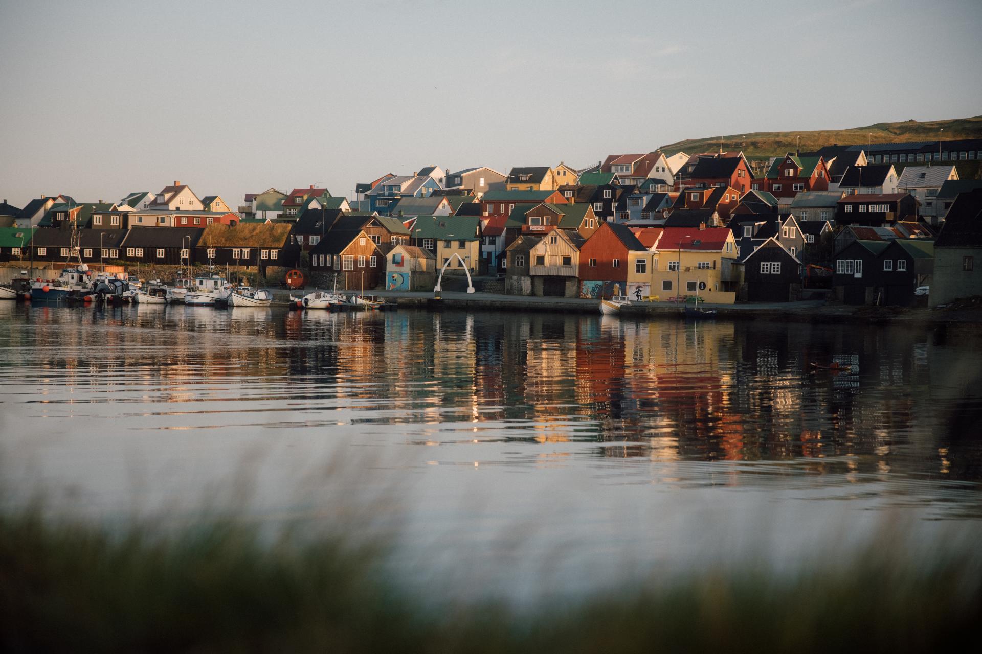 Thumbnail of - Colorful homes in Nólsoy, Faroe Islands. Harbor with boats and sunny surroundings. 