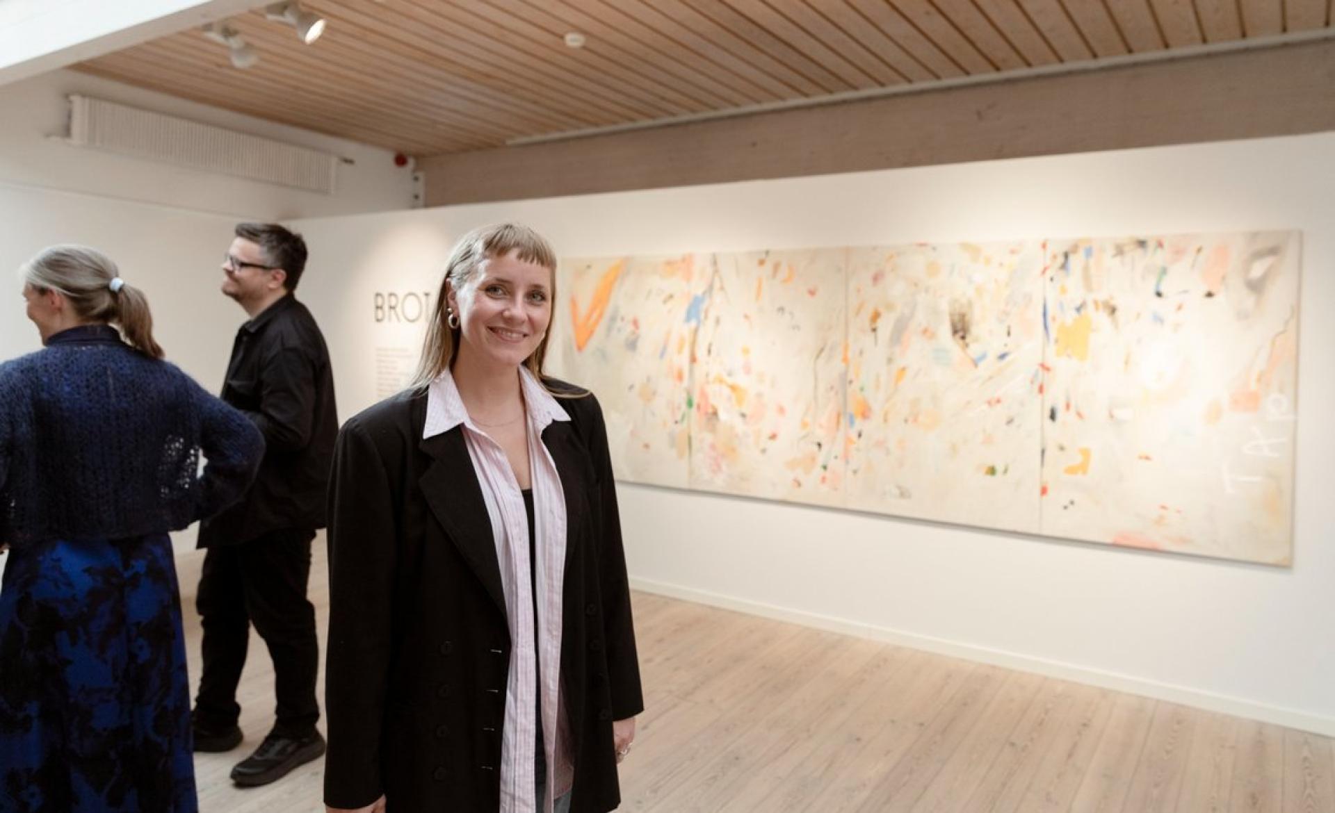 Thumbnail of - Kirstin Helgadóttir with her artwork, displayed at the National Gallery in the Faroe Islands.