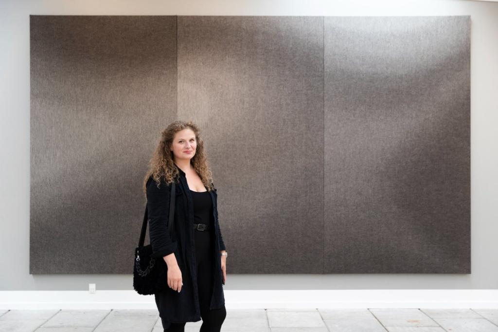 Ragnhild Hjalmarsdóttir Højgaard with her artwork, displayed at the National Gallery in the Faroe Islands.