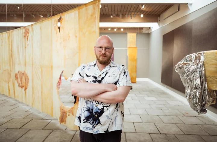 Thumbnail of - Jón Sonni Jensen with his artworks displayed at the National Gallery in the Faroe Islands. 