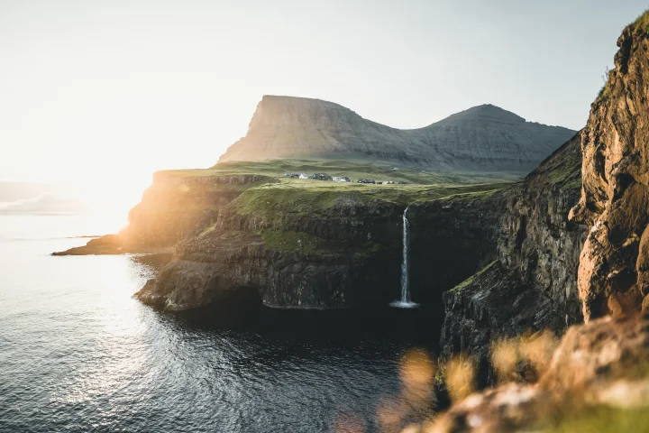 Gásadalur waterfall (Múlafossur), sun and green nature in the Faroe Islands