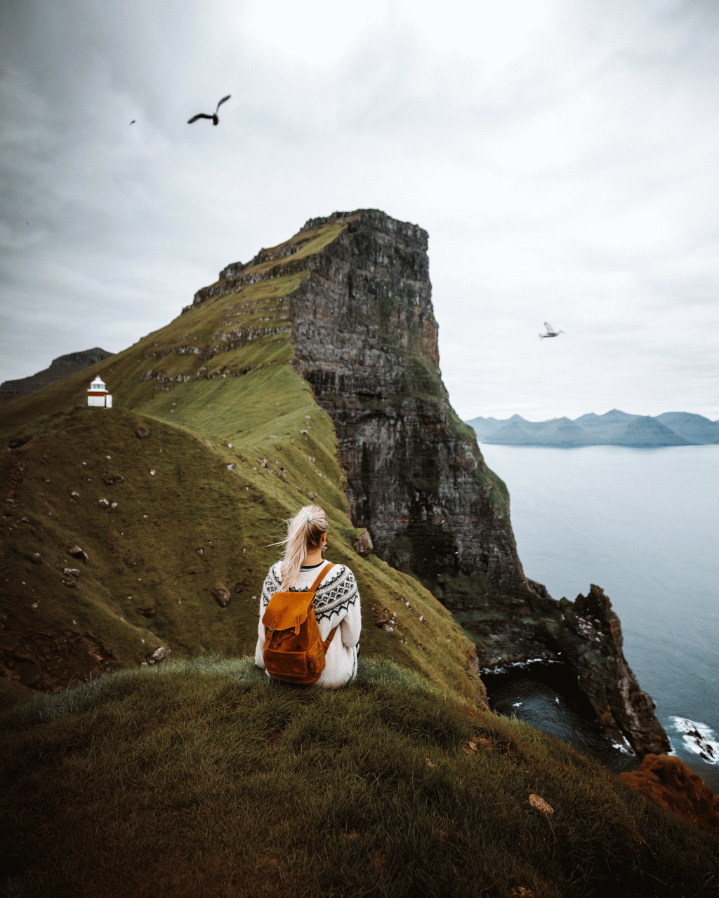 Female enjoying the view at Kallurin, in the Faroe Islands