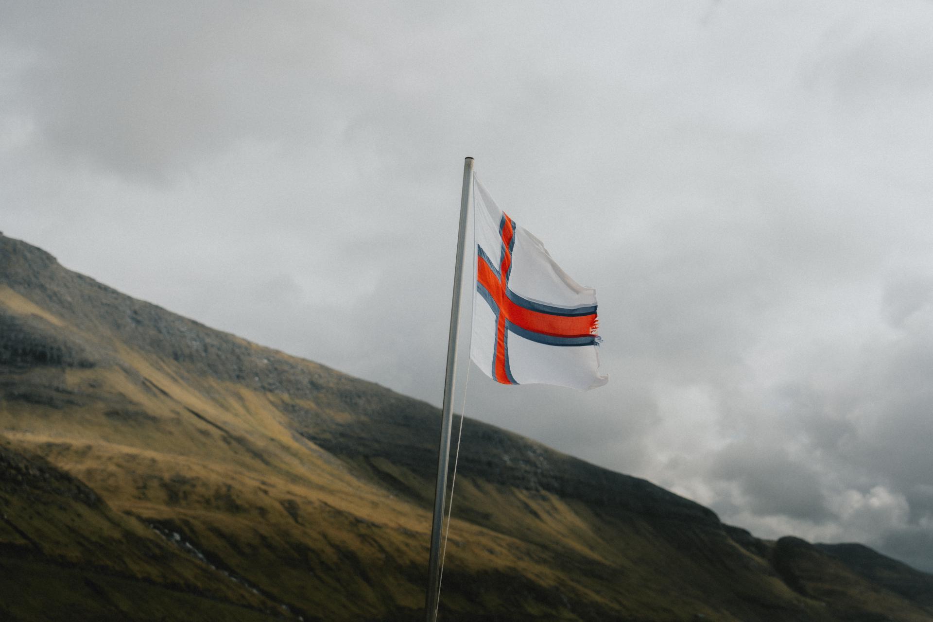 How old is the Faroese flag? What does the flag of the Faroe Islands look like?  What does Merkið mean?