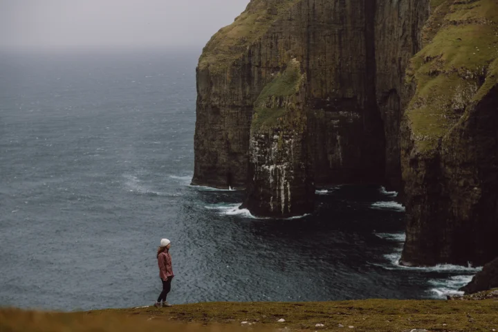 Suðuroy, a traveller hiking in the mountains.