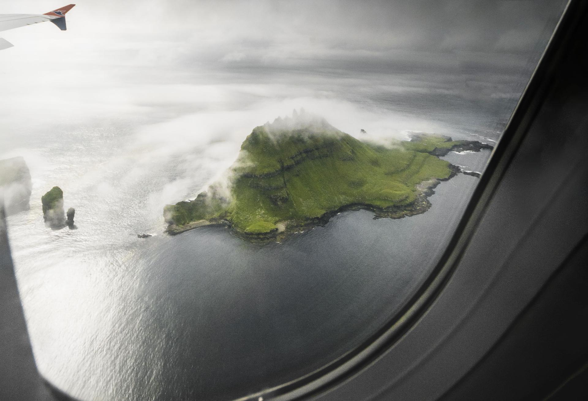 Thumbnail of - Window view of the Atlantic Airways inflight to the mountainous Faroe Islands